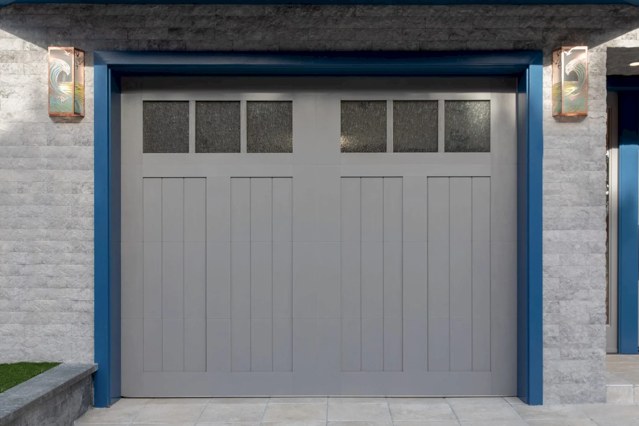 Exterior shot of a one car garage door with blue trim