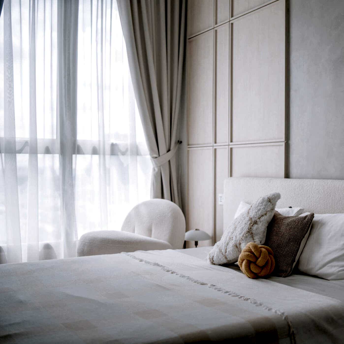 brightly lit bedroom beside window